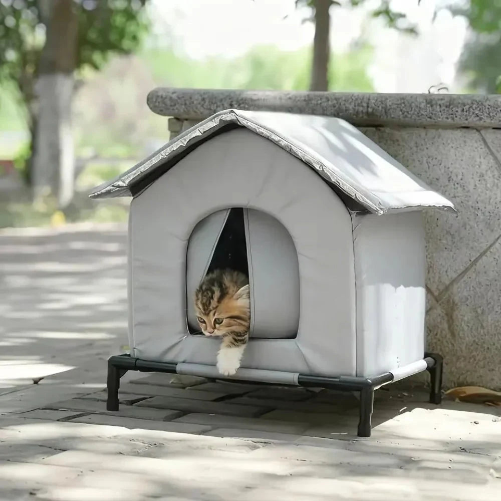 Niche chat extérieur isolée et étanche gris clair avec un chaton à l'intérieur, sur une terrasse